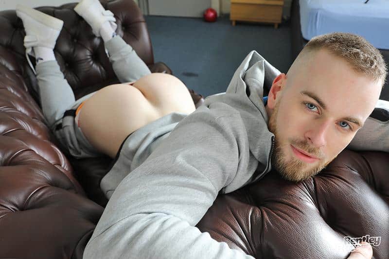 Sexy hairy chested young muscle dude Maxwell Millers strips out of his sports kit stroking his huge uncut dick image